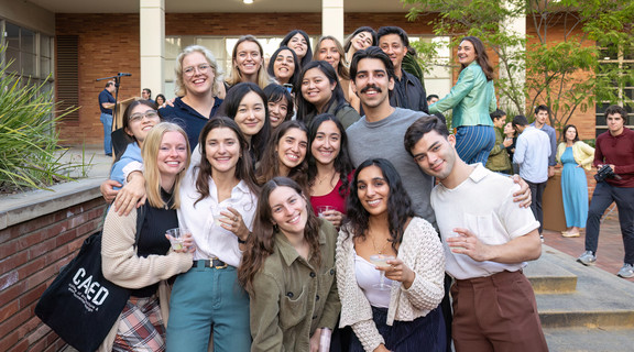 Students standing on ladder to pin up their work on the walls