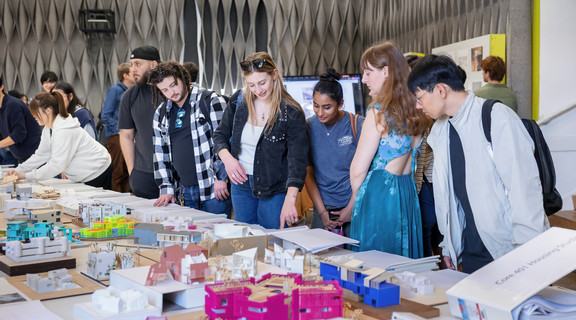 A female student sitting at a desk smiling