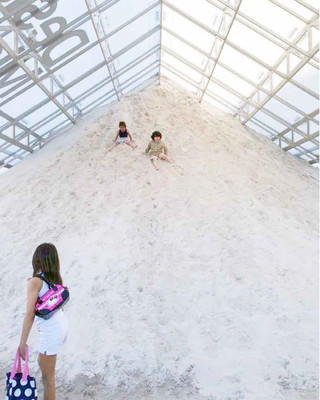 Image of children playing on a sand mound in the Tentpile pavillion
