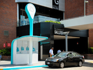 Image of a Curbside Pickup Pod outside Glendale Galleria, a blue-and-white fiberglass kiosk that allows you to shop via an app and conveniently pickup orders from retailers.