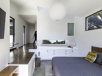 Interior image of a bedroom looking through to a hallway