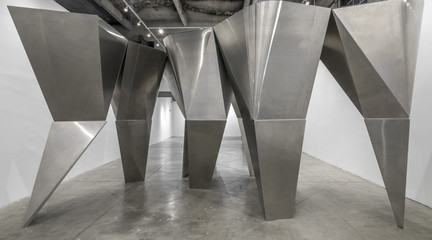 Image of En Pointe, an installation of a group of large, angular aluminum-clad columns at the SCI-Arc Gallery in Los Angeles.