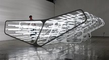 Image of an installation made of articifial light and steel in a gallery space