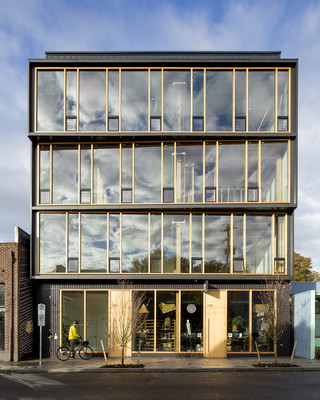 Image of a facade of a glass building with wood beams