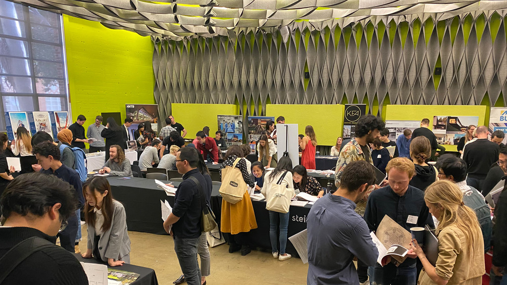 Image of people gathering in a large hall