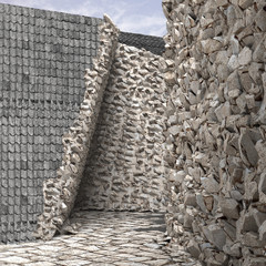 Rough, grey stone wall juxtaposed with wall covered in black shingles.